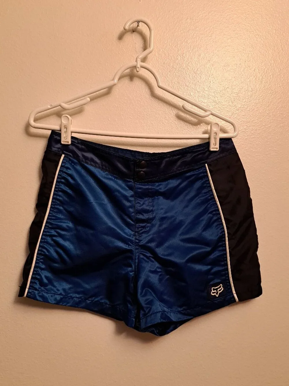 Vintage Fox Racing board shorts featuring a blue satin finish &white piping.
